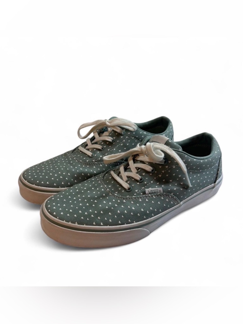 Vans Authentic featuring a green canvas upper with a white heart pattern.